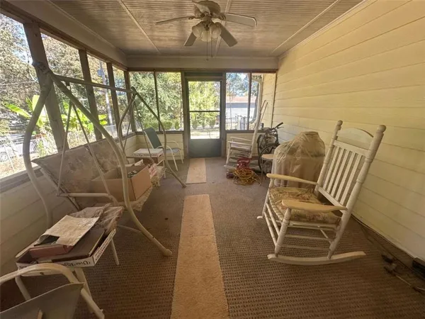 a bedroom with furniture and a flat screen tv