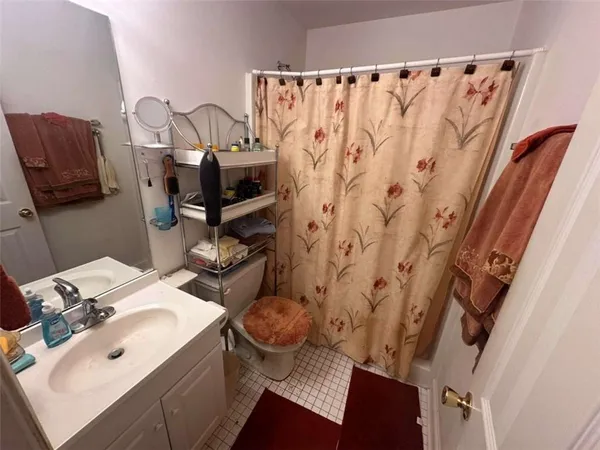 a bedroom with furniture and a mirror