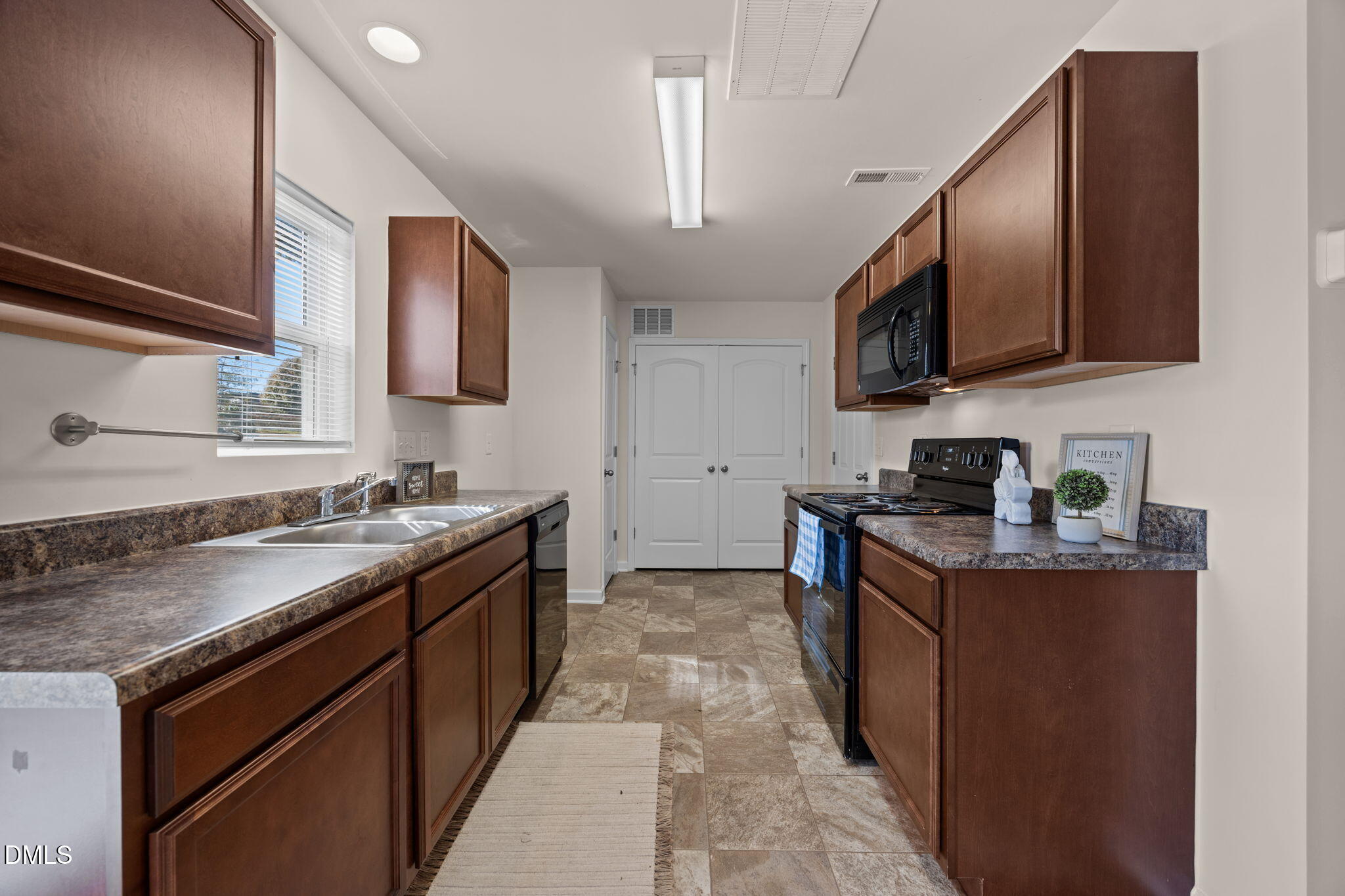 107 Deanne Lane Coats, NC 27521 - Photo 11 of 35 a kitchen with stainless steel appliances granite countertop a sink stove and microwave