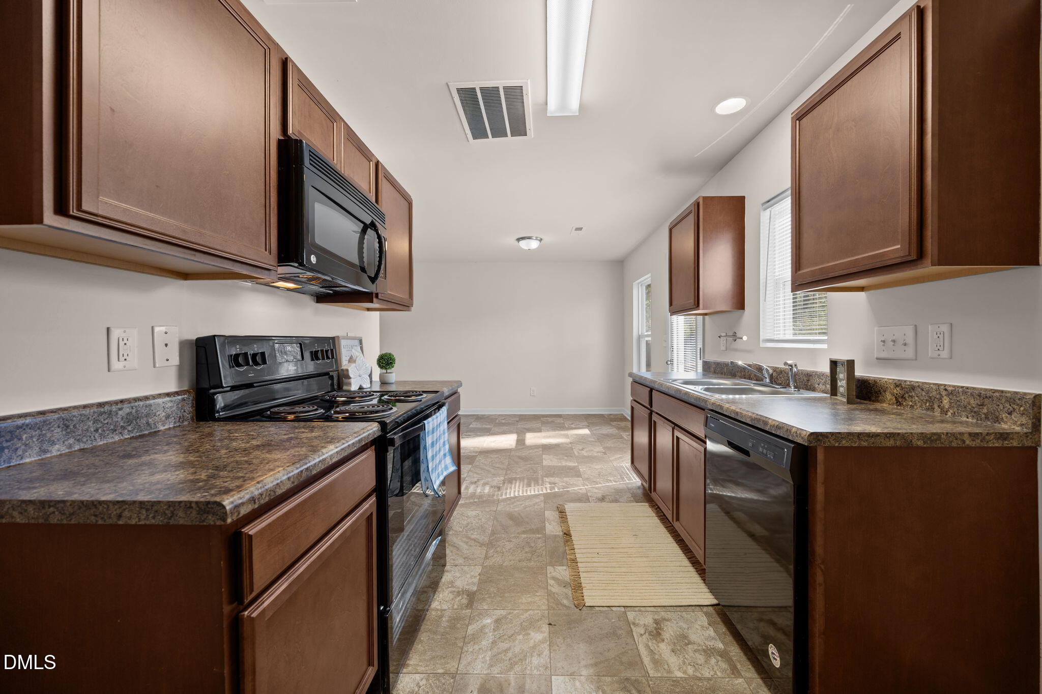 107 Deanne Lane Coats, NC 27521 - Photo 13 of 35 a kitchen with stainless steel appliances granite countertop a stove a sink and a microwave