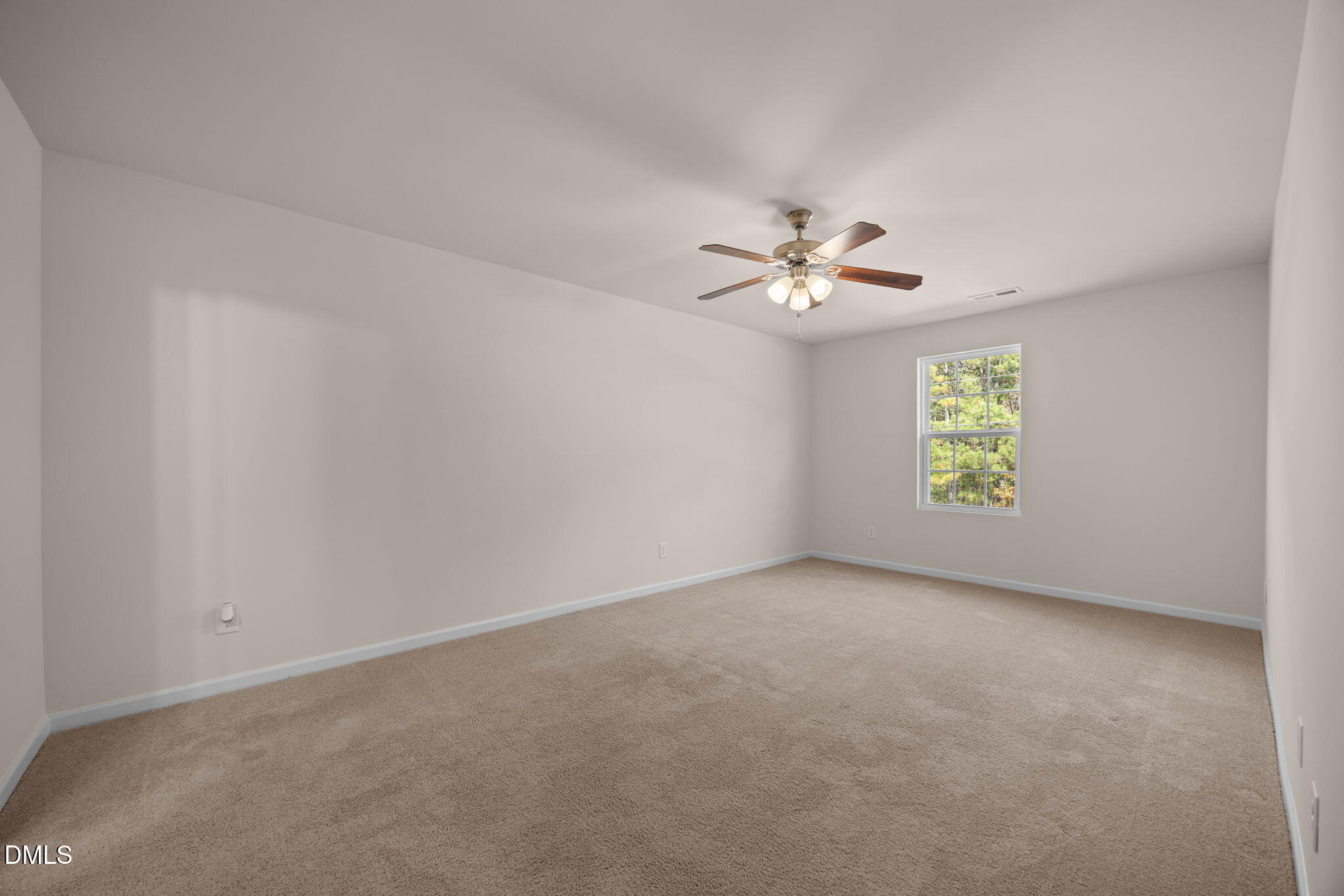 107 Deanne Lane Coats, NC 27521 - Photo 15 of 35 an empty room with windows and chandelier fan