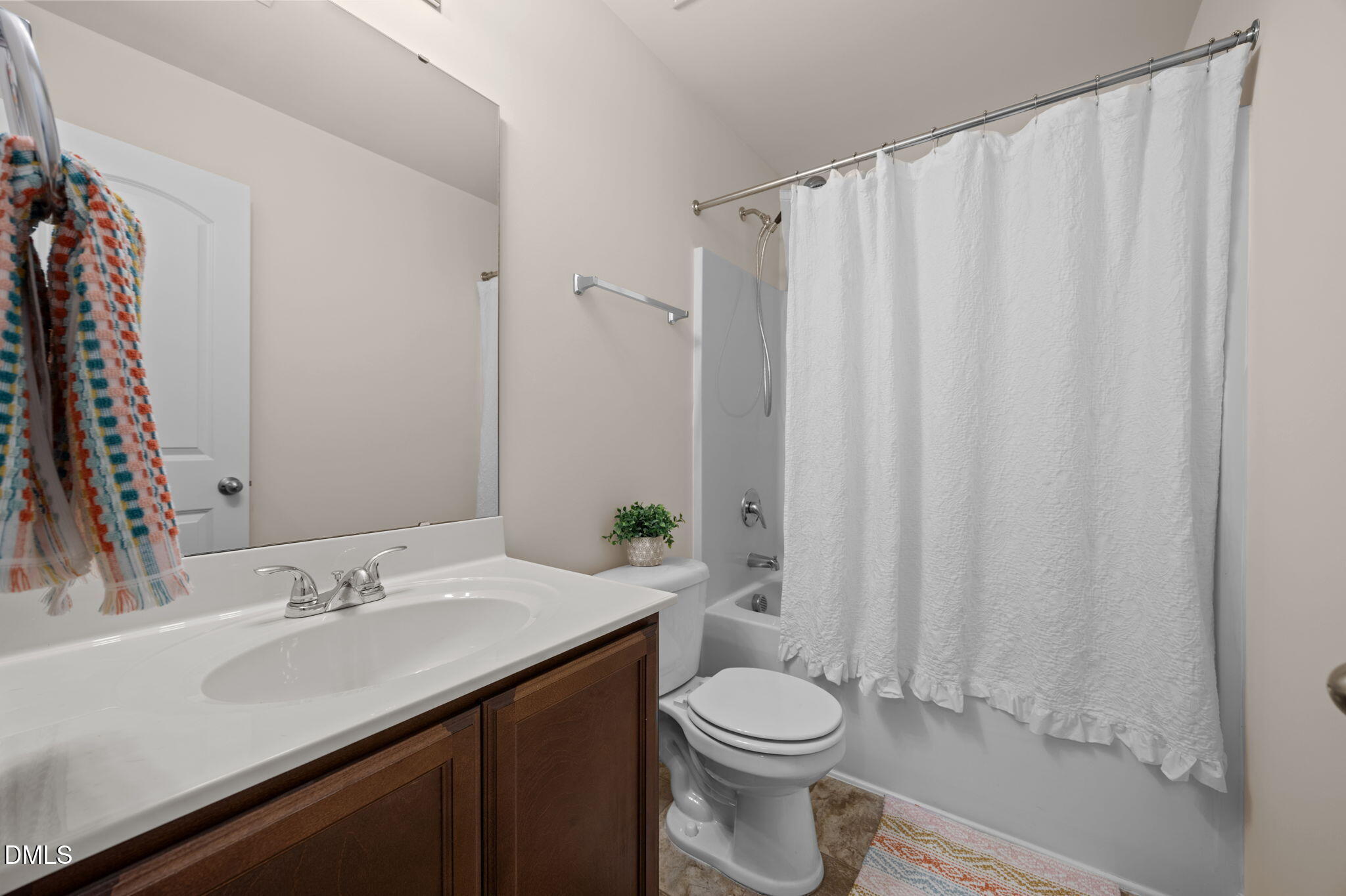 107 Deanne Lane Coats, NC 27521 - Photo 23 of 35 a bathroom with a sink a toilet and a mirror