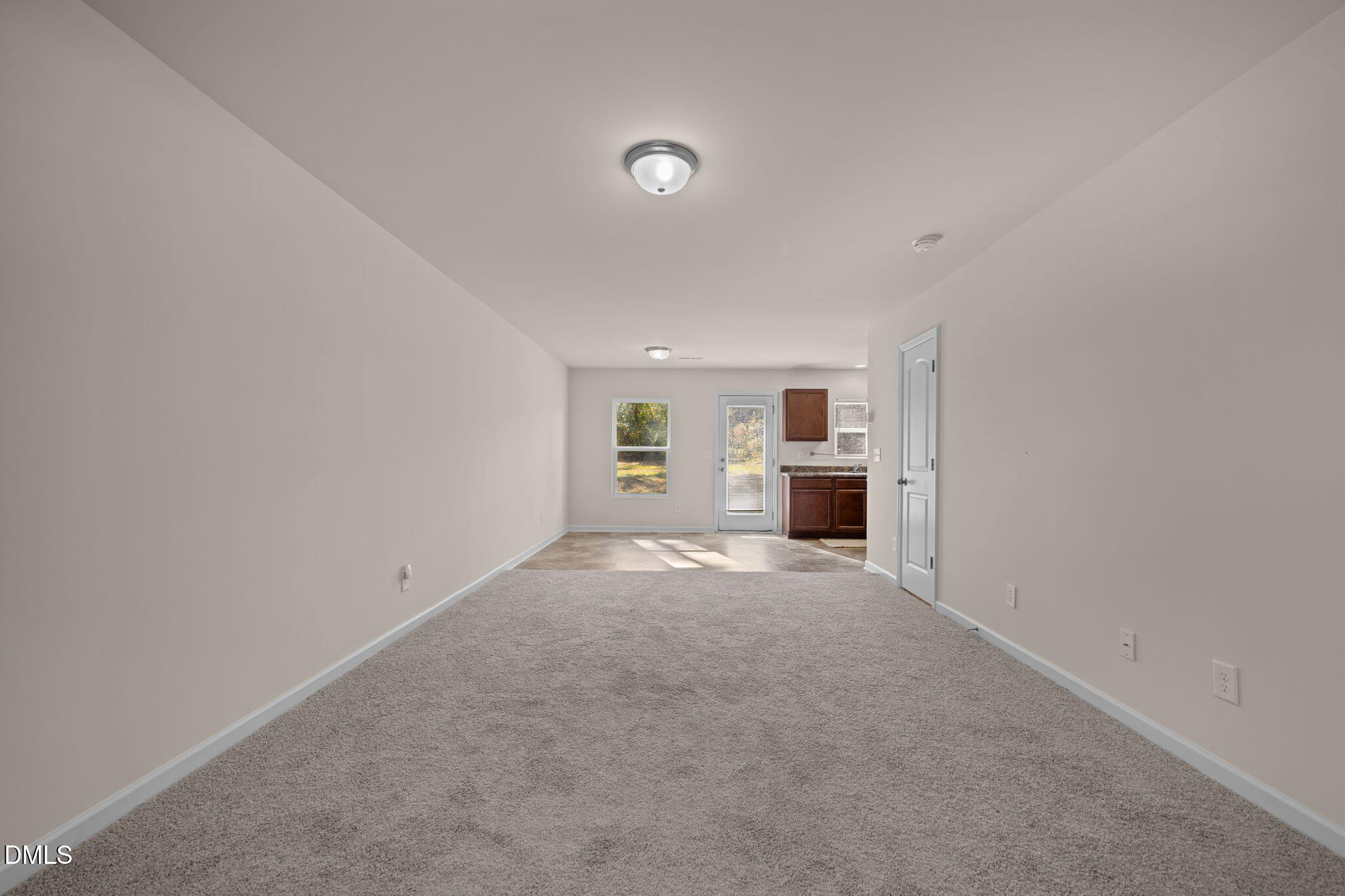 107 Deanne Lane Coats, NC 27521 - Photo 4 of 35 a view of empty room with a kitchen