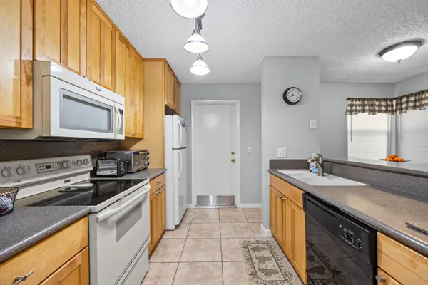 a kitchen with a sink stove and cabinets