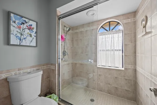 a bathroom with a toilet and a shower