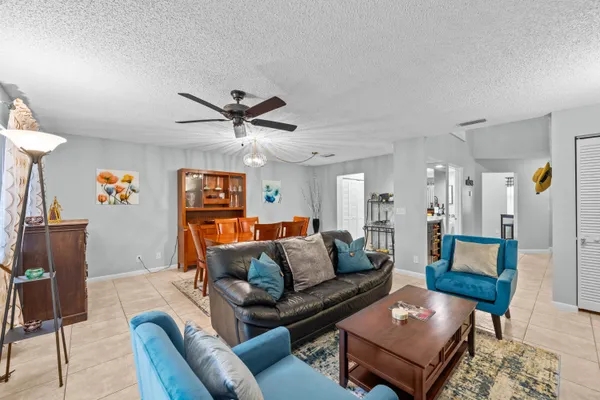 a living room with furniture and a ceiling fan