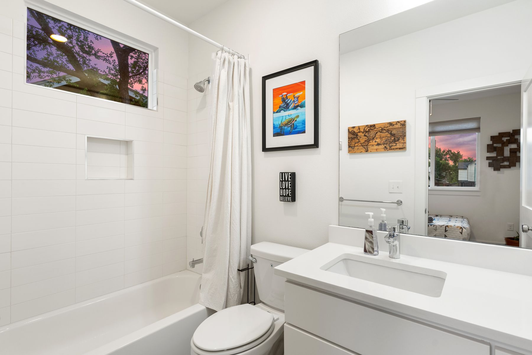 1709 Perez Street, Unit 2 Austin, TX 78721 - Photo 28 of 33 A well-appointed bathroom with a sleek vanity and a shower-tub combination.