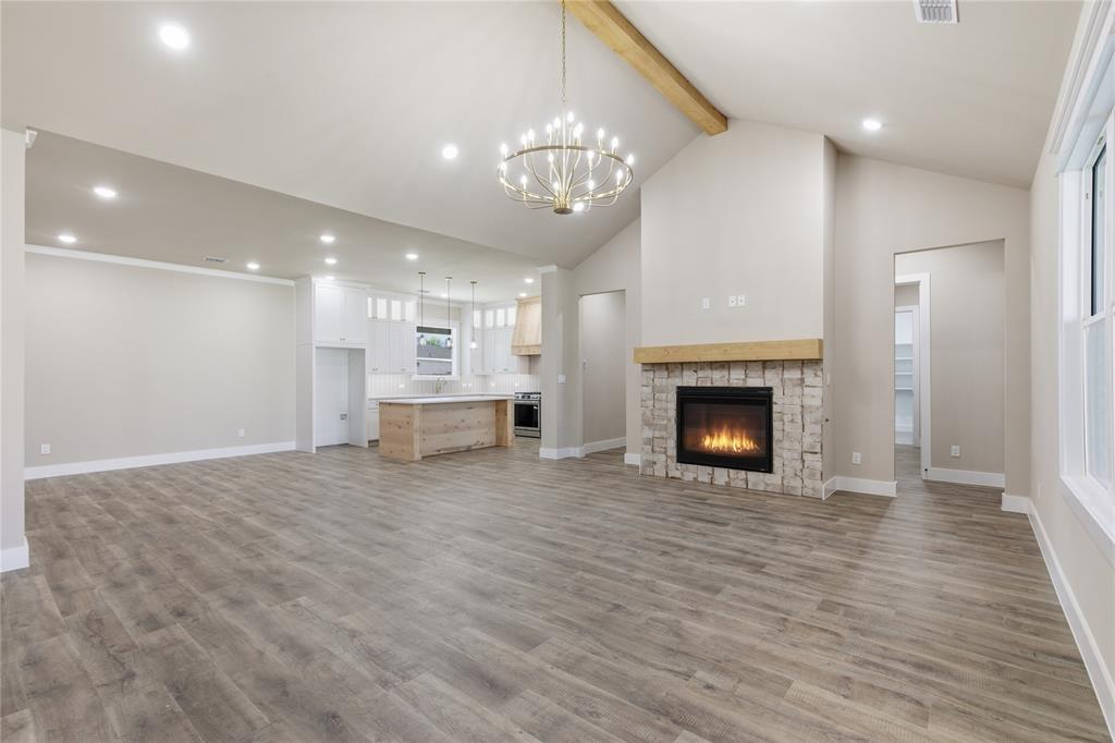 709 Anne Road Van Alstyne, TX 75495 - Photo 4 of 28 Open concept living space featuring wood-finish flooring, a vaulted ceiling, and recessed lighting