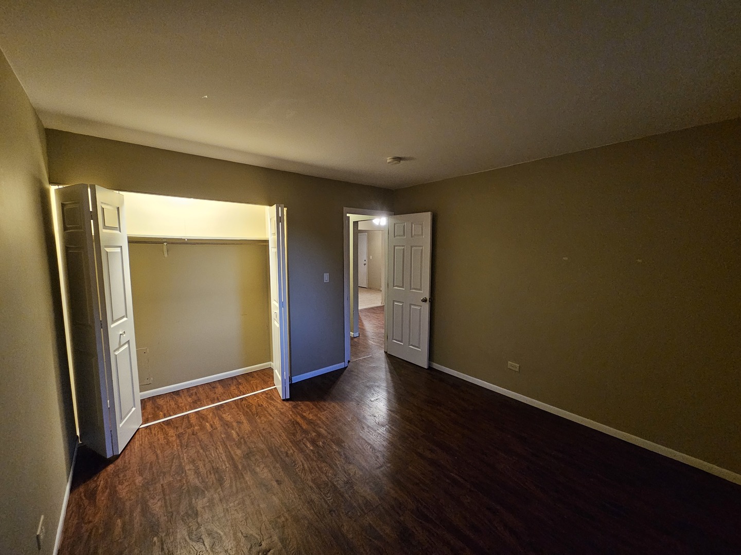 737 Lippert Lane, Unit 2N Glendale Heights, IL 60139 - Photo 12 of 15 an empty room with wooden floor and windows