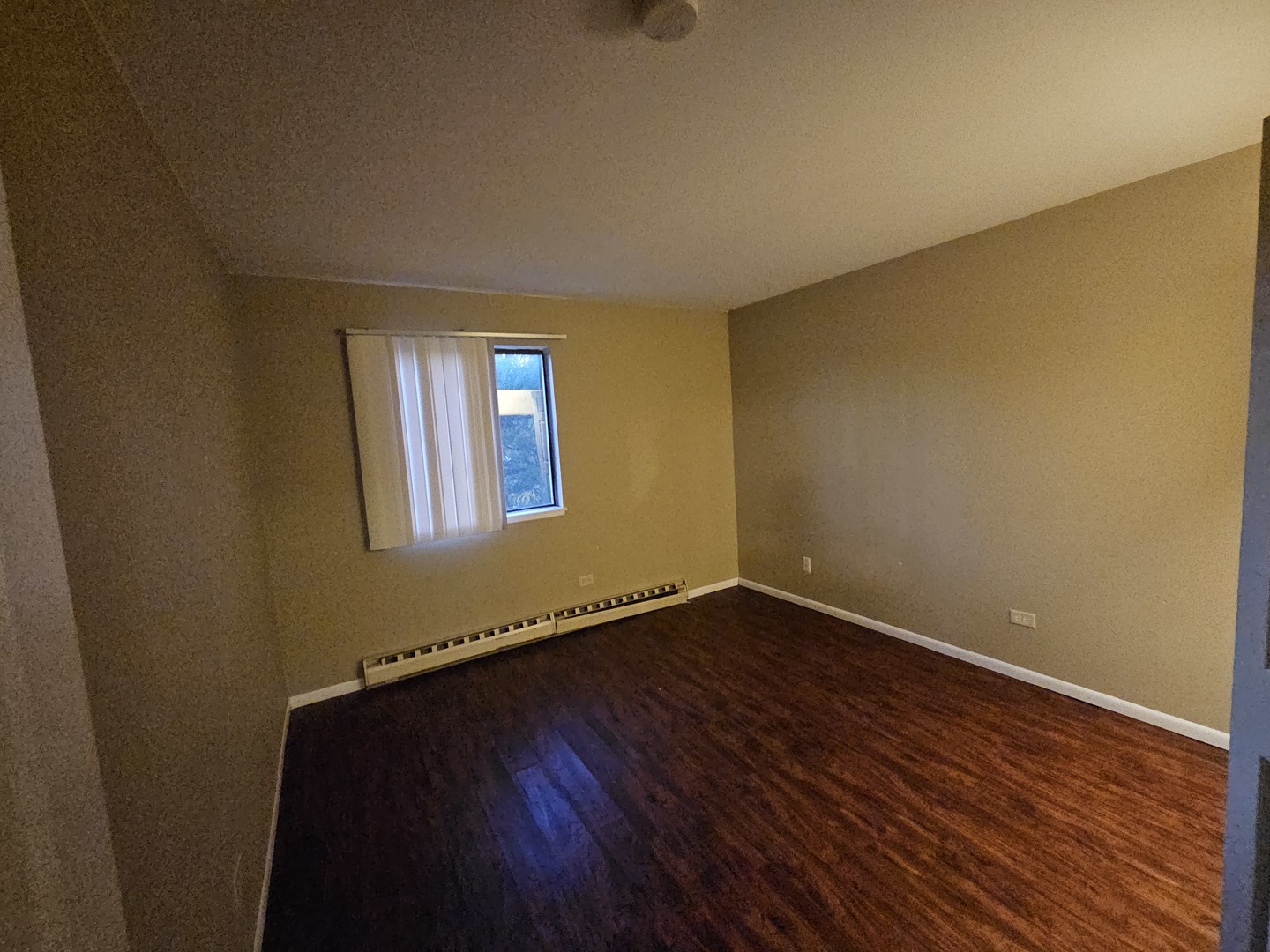 737 Lippert Lane, Unit 2N Glendale Heights, IL 60139 - Photo 13 of 15 a view of an empty room with wooden floor and a window