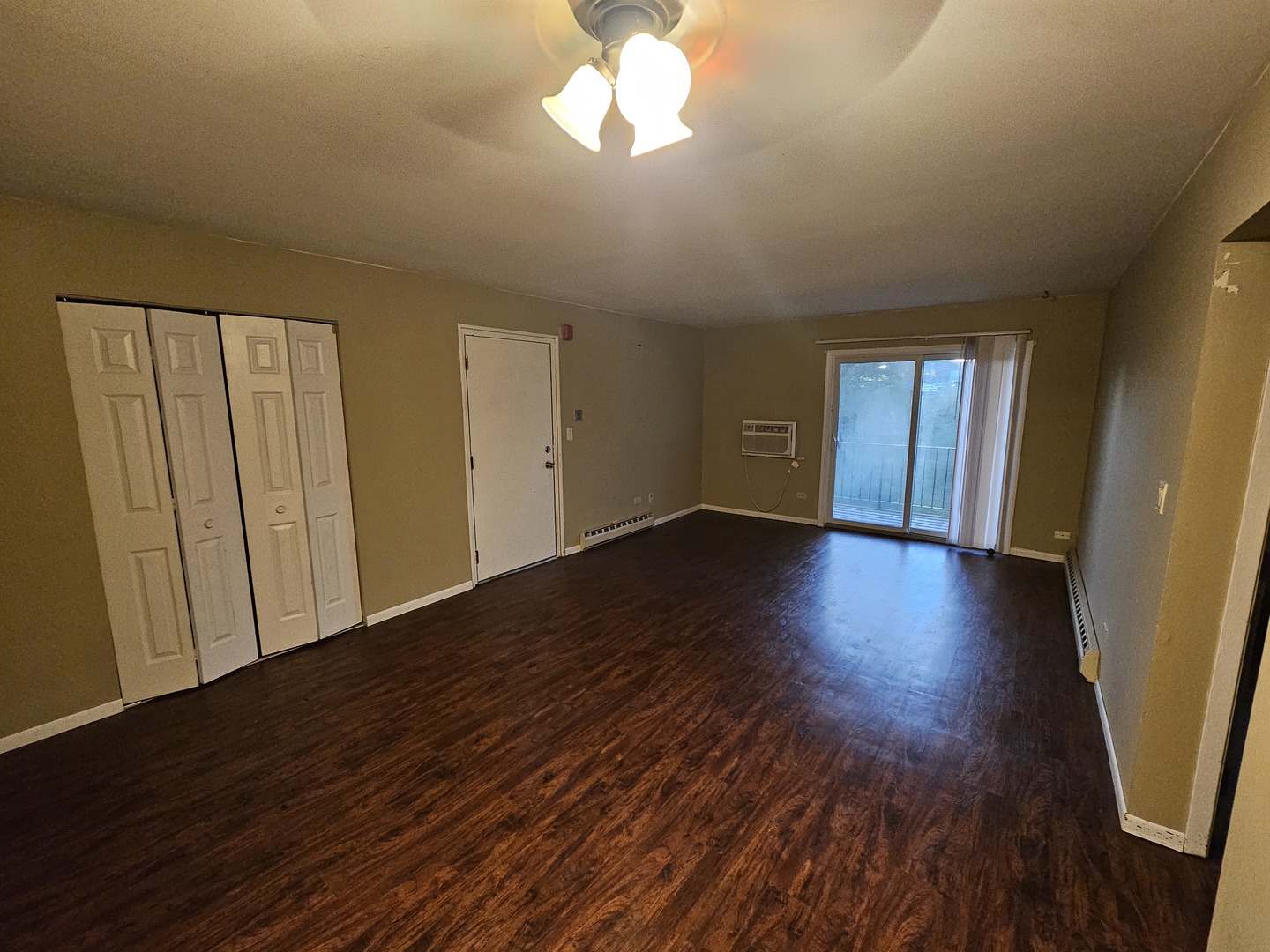 737 Lippert Lane, Unit 2N Glendale Heights, IL 60139 - Photo 7 of 15 a view of an empty room with wooden floor and a window