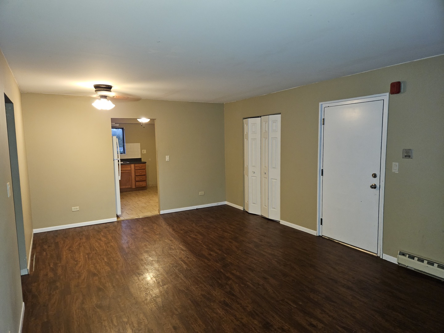 737 Lippert Lane, Unit 2N Glendale Heights, IL 60139 - Photo 10 of 15 an empty room with wooden floor and a ceiling fan