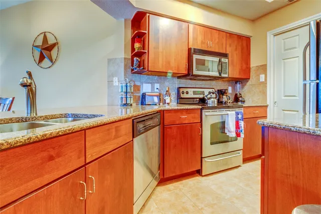 a kitchen with stainless steel appliances granite countertop a stove and a sink