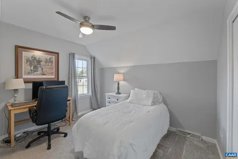 a bedroom with a bed a desk and chair