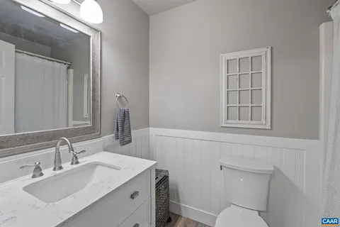 a bathroom with a sink toilet and vanity