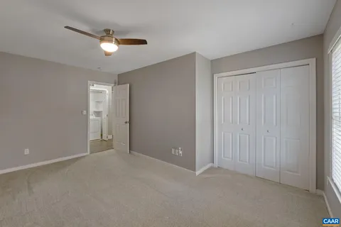 a view of an empty room with a fan