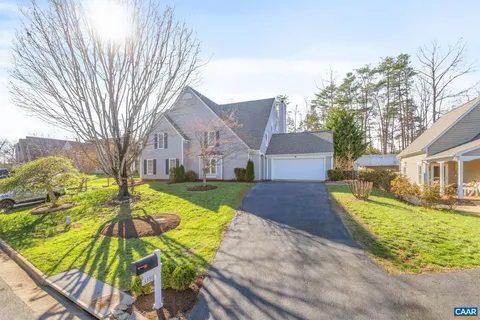 a view of a house with a yard patio and fire pit