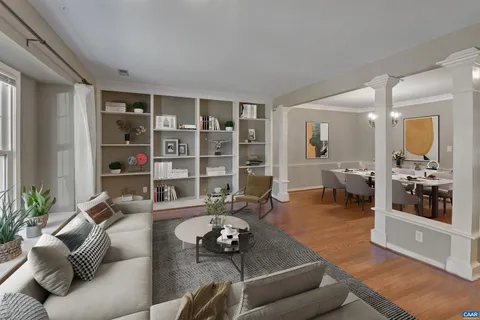 a living room with furniture and wooden floor
