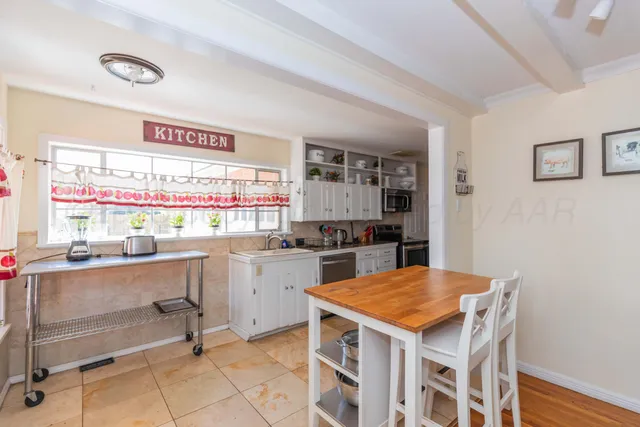a kitchen with a table and chairs in it