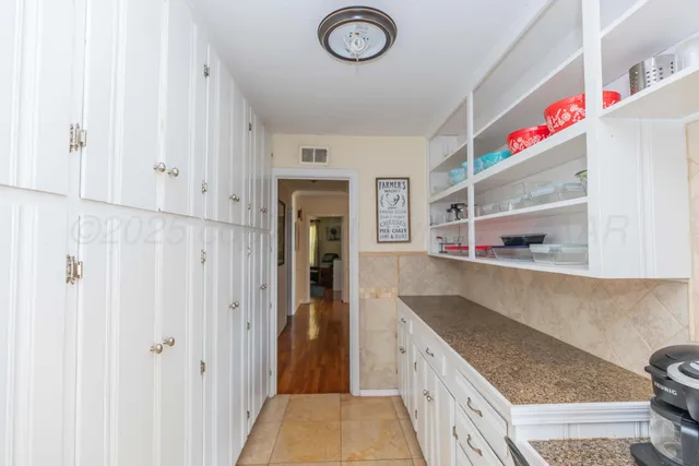 a kitchen with cabinets and window