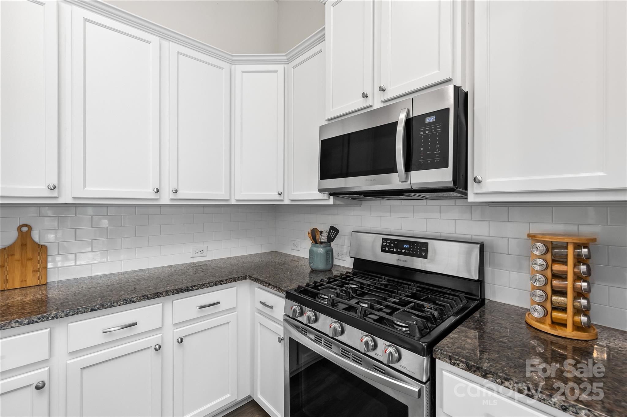4515 Dover Court Denver, NC 28037 - Photo 16 of 41 a kitchen with stainless steel appliances granite countertop white cabinets and a stove