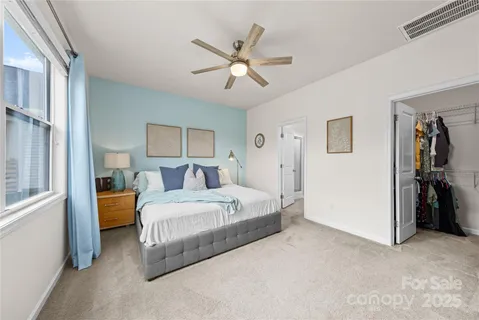a bed room with a bed and a ceiling fan