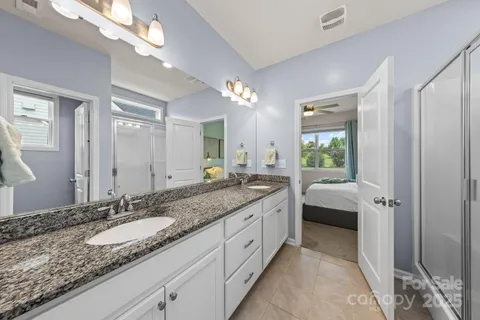 a spacious bathroom with a granite countertop sink and a mirror