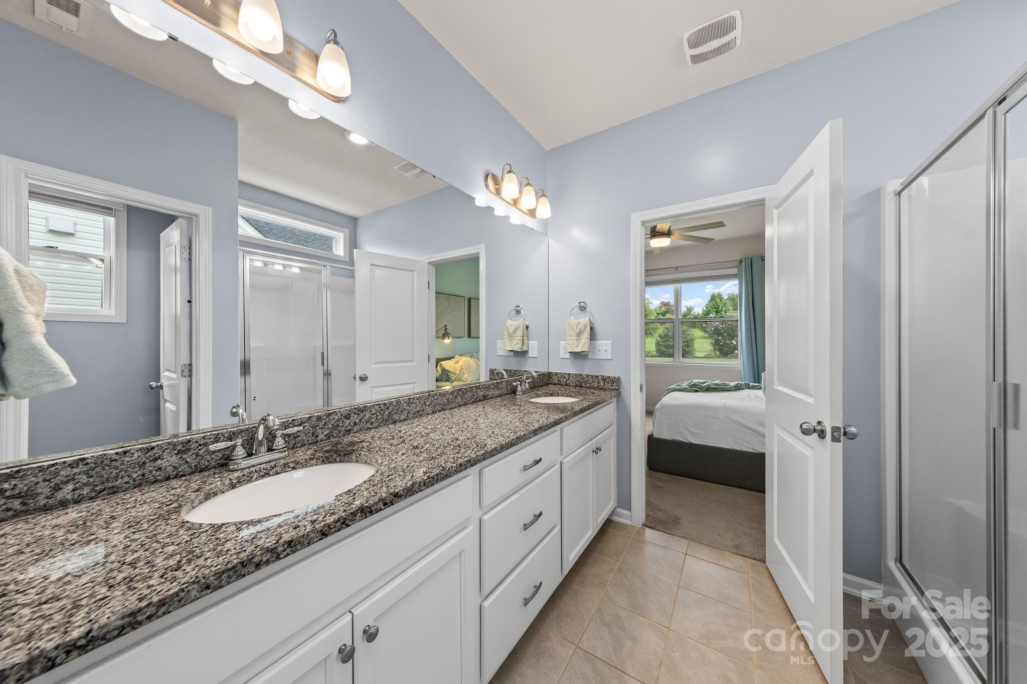 4515 Dover Court Denver, NC 28037 - Photo 20 of 41 a spacious bathroom with a granite countertop sink and a mirror