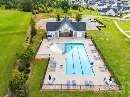 an aerial view of a house with a yard basket ball court and outdoor seating