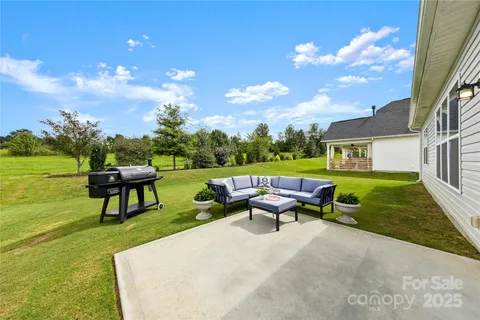an aerial view of a house with a yard basket ball court and outdoor seating