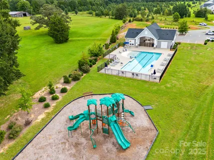 a view of a house with swimming pool and porch