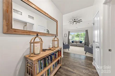 a view of hall way with furniture and staircase