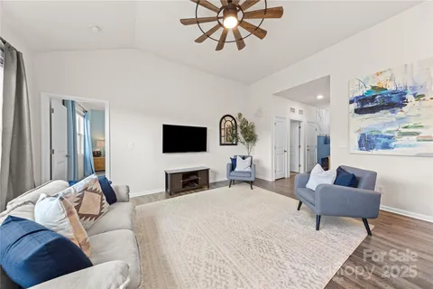 a spacious bedroom with a bed a couch and a flat screen tv