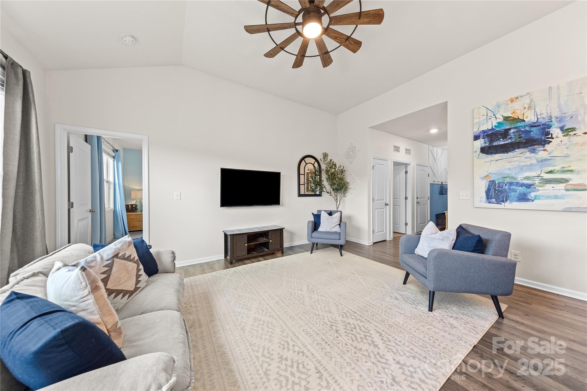4515 Dover Court Denver, NC 28037 - Photo 9 of 41 a spacious bedroom with a bed a couch and a flat screen tv