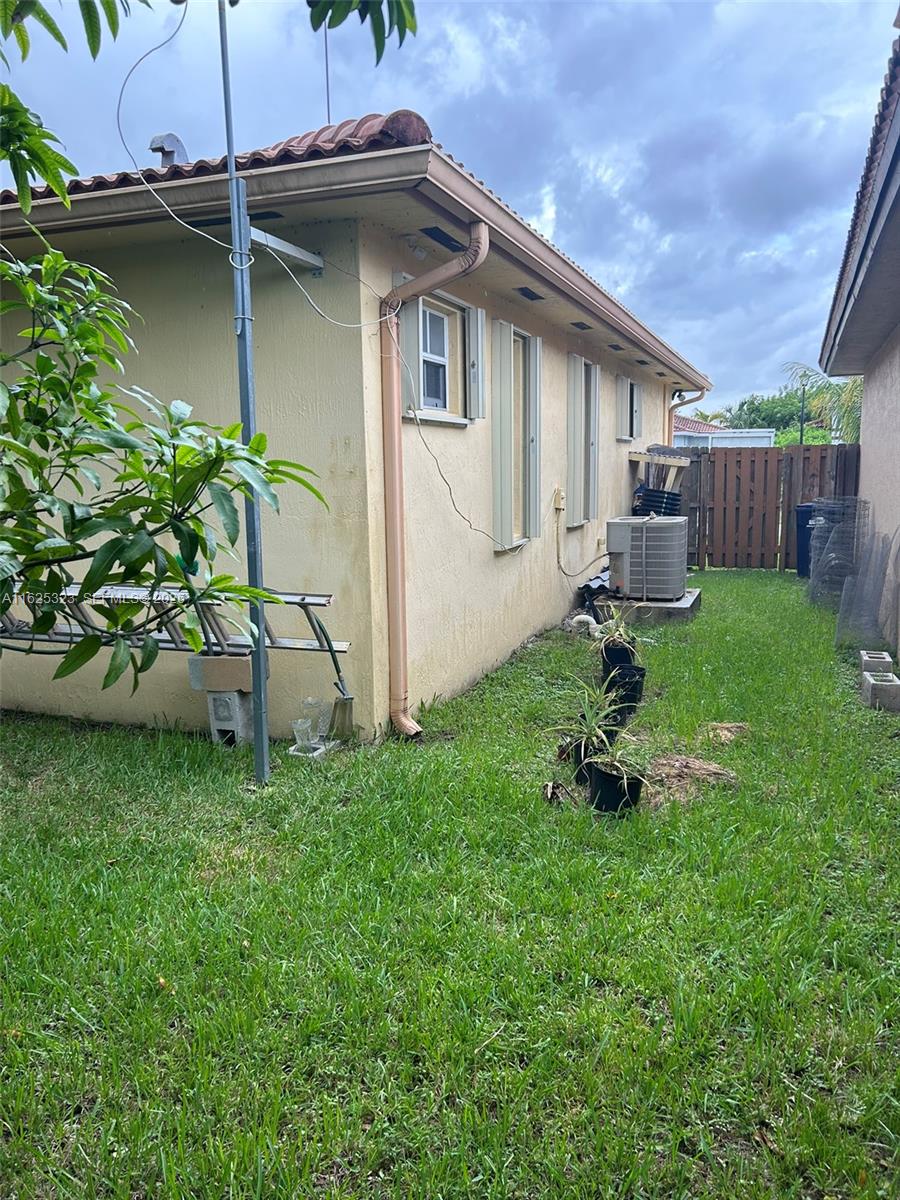 12414 Southwest 213th Street Miami, FL 33177 - Photo 12 of 15 a backyard of a house with table and chairs