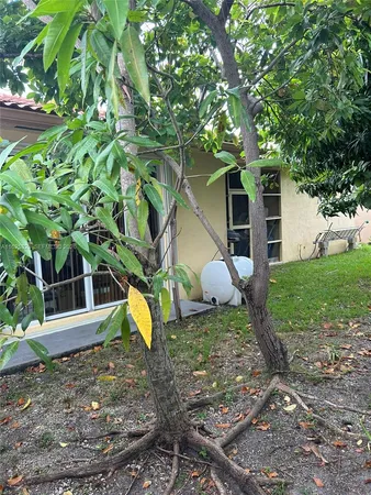 a view of a house with a yard and sitting area
