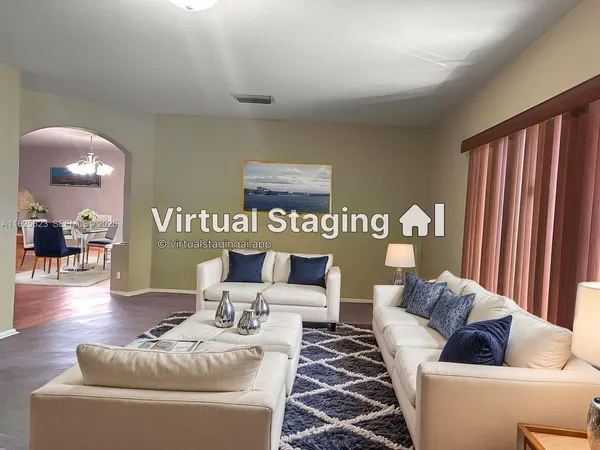 a living room with furniture and a large mirror