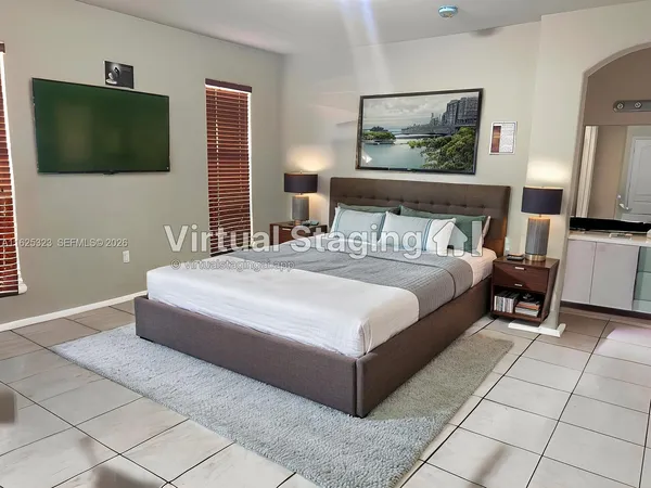 a bedroom with a bed and a flat screen tv