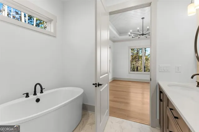 an empty room with a window and ceiling fan