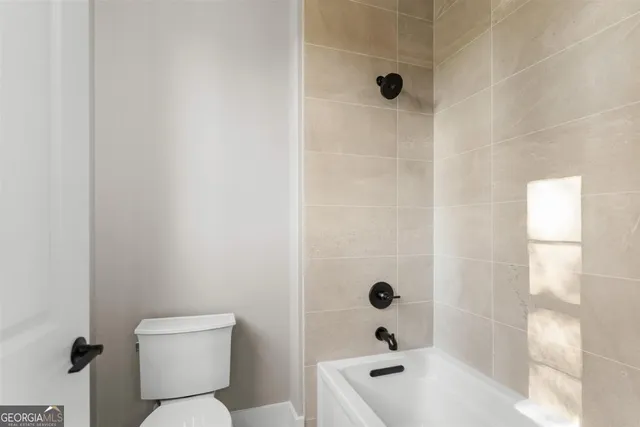 a view of a house with snow on the side of the road