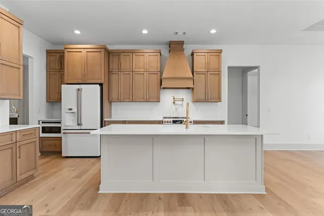 a view of an empty room with wooden floor fireplace and a window