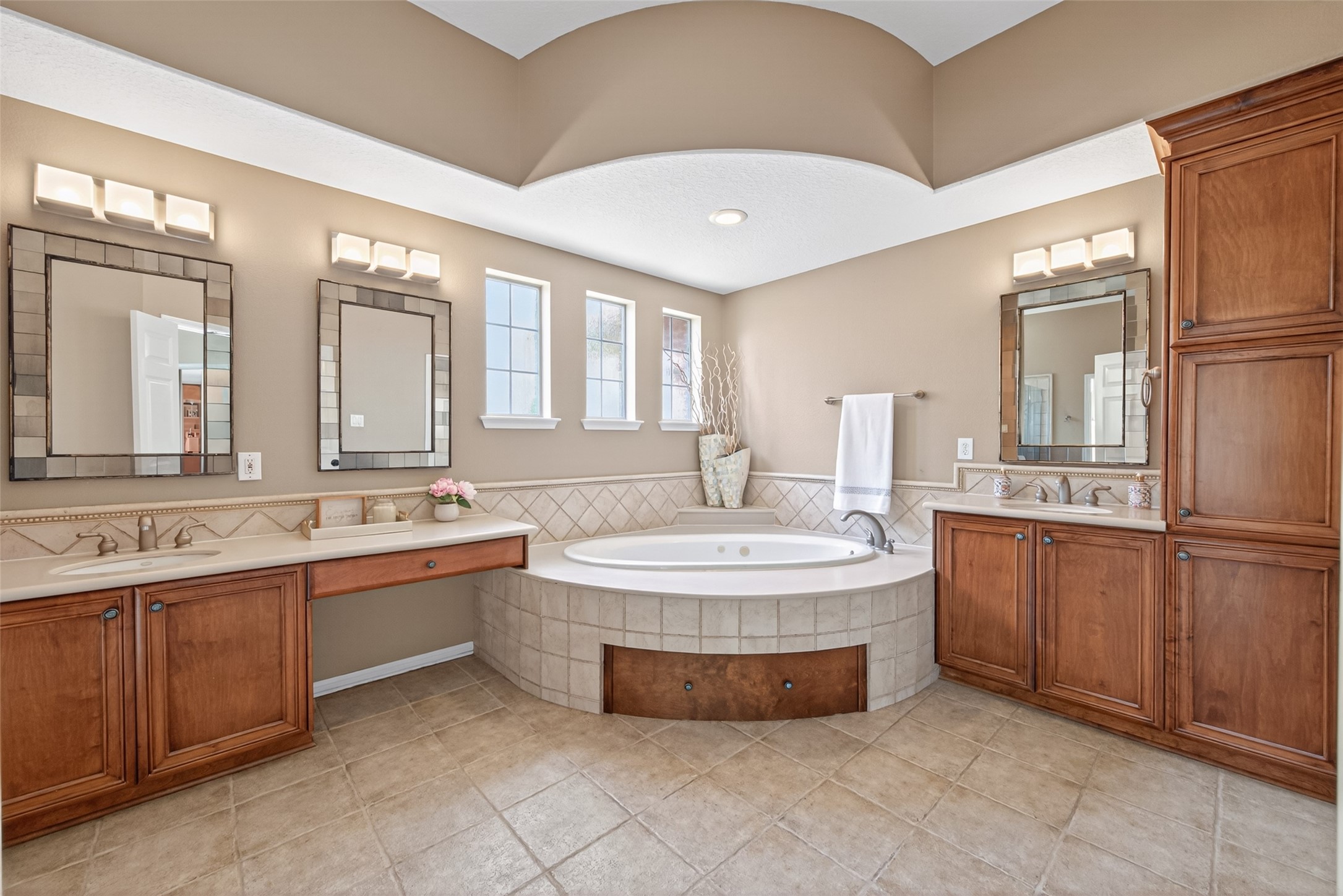 10 Mirror Ridge Drive The Woodlands, TX 77382 - Photo 25 of 48 The ensuite primary bathroom features double sinks, a dedicated powder area, a Jacuzzi bathtub, ample cabinetry for storage, and a separate shower