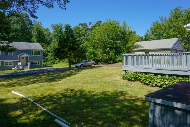 a view of a porch with furniture and garden
