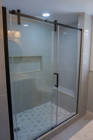 a bathroom with a glass shower door