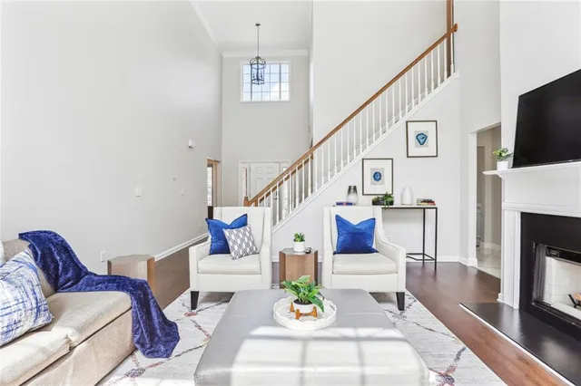 a living room with furniture a fireplace and a flat screen tv