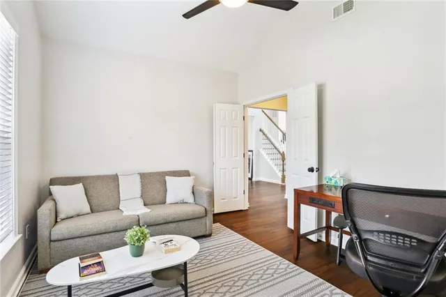 a living room with furniture and wooden floor