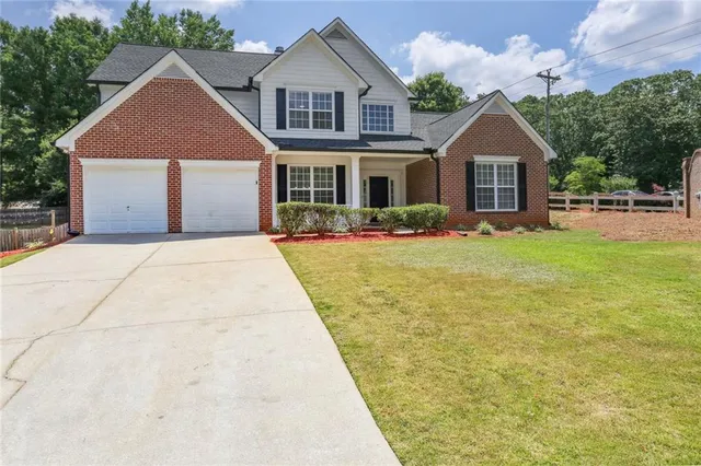 a front view of a house with yard