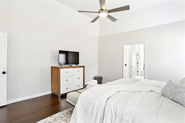 a bedroom with a bed and a tv on the dresser