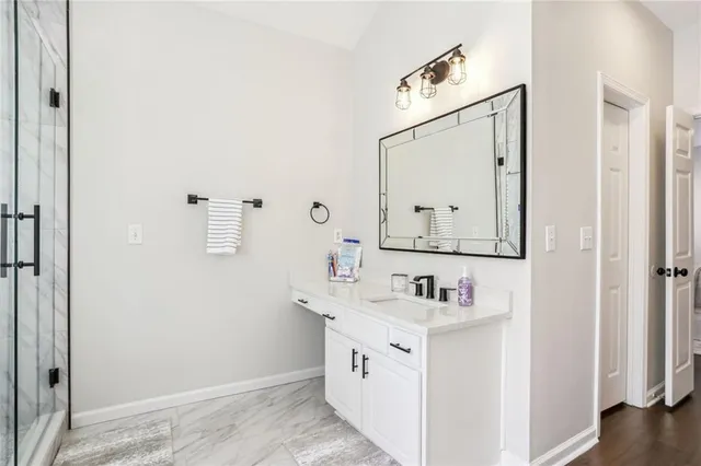 a bathroom with a sink vanity and a mirror
