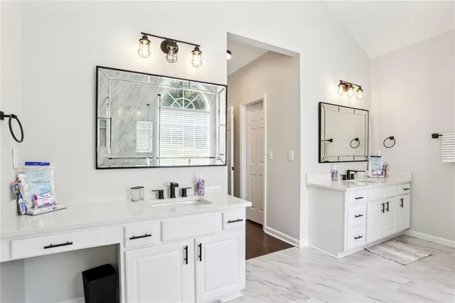 a bathroom with a sink vanity and mirror